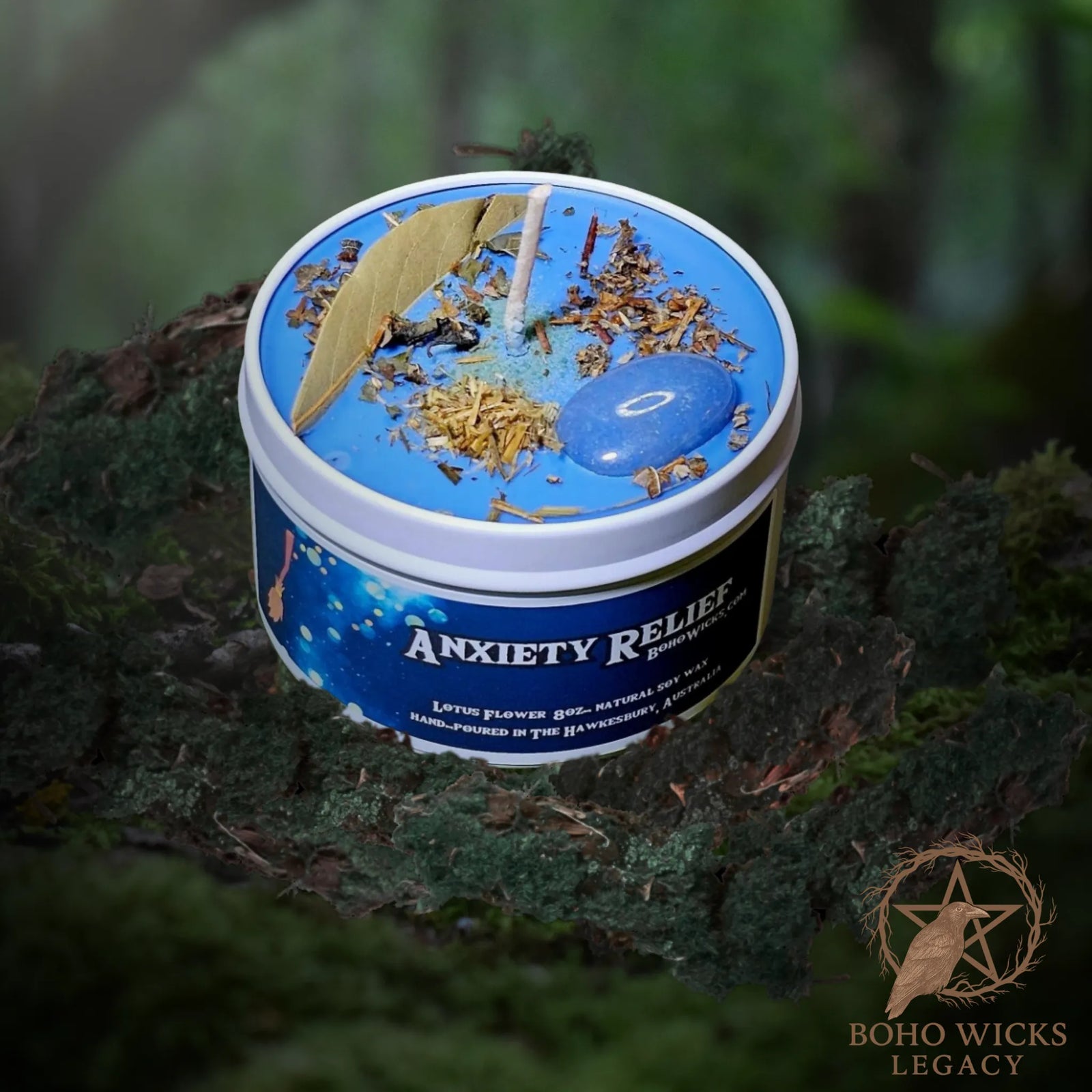 Forest setting photo of the Anti-Anxiety candle with Blue Quartz, Lemon Balm, Oat Straw, Agrimony, and Myrrh surrounded by moss, fragranced with Lotus Flower