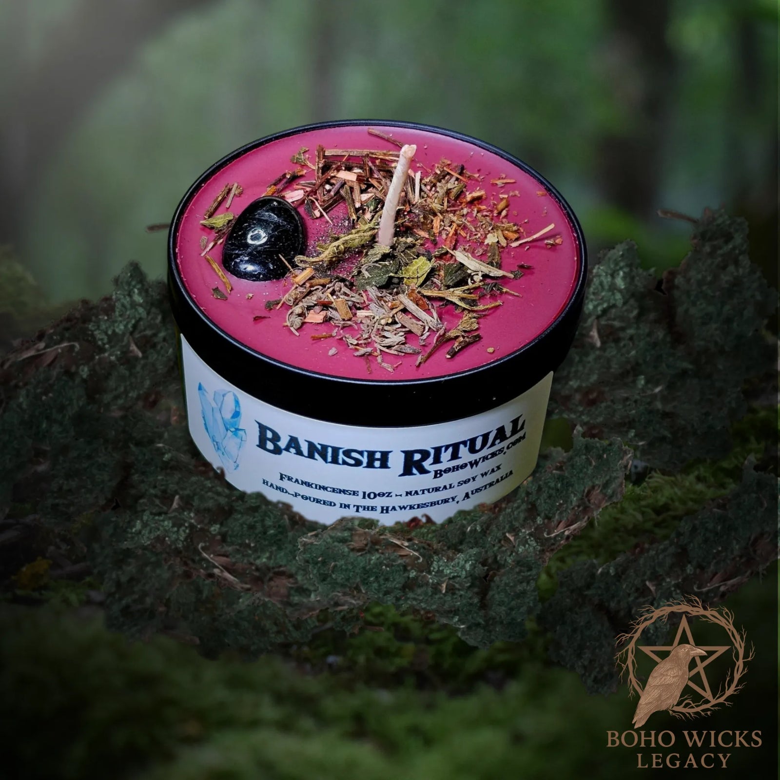 Forest setting photo of the Banish candle with Black Tourmaline, Agrimony, Nettle, Vervain, and Wormwood surrounded by moss, fragranced with Frankincense