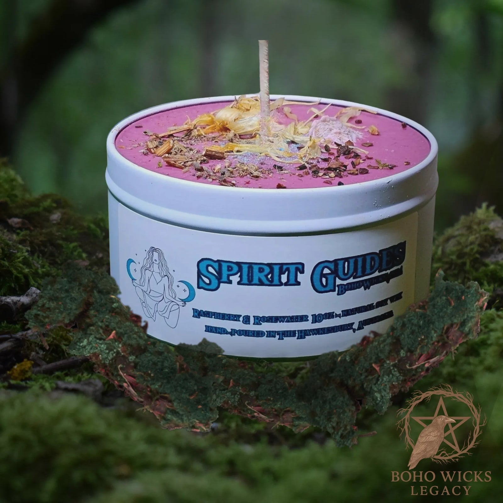 Forest setting photo of the Spirit Guides candle with Desert Rose, Bladderwrack, Marigold, and Wormwood surrounded by moss, fragranced with Raspberry & Rosewater