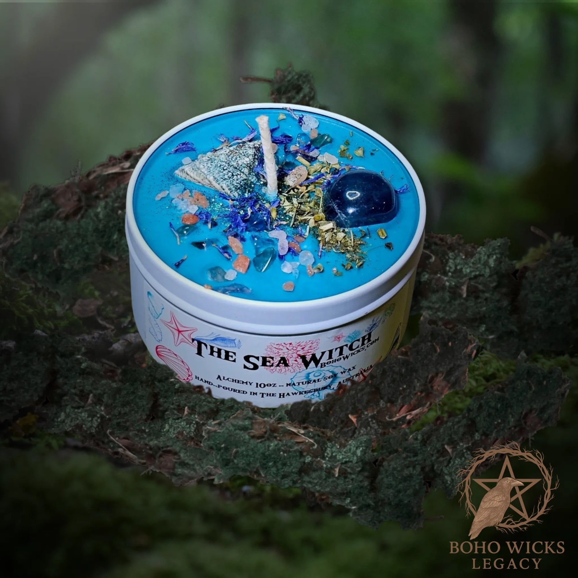 Forest setting photo of The Sea Witch candle with Fluorite, Cornflowers, Skullcap, Seashells, and Sea Salt surrounded by moss, fragranced with Alchemy