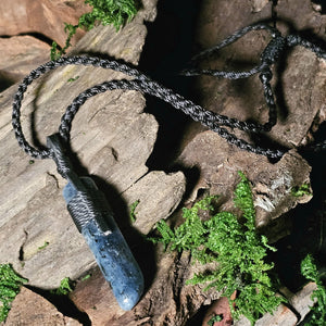 Pendant necklace with indigo kyanite staged with moss and bark
