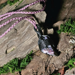 Crystal pendant featuring purple charoite and lavender cord
