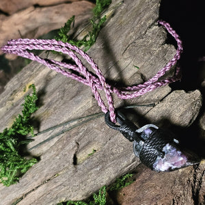 Purple and black charoite crystal in woven pendant form
