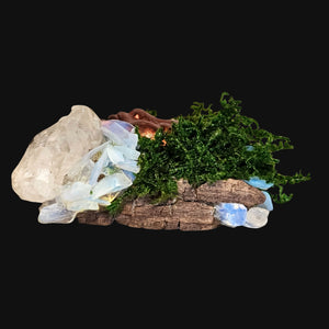 Close-up of copper-bronze Forest Guardian face and crystals — elemental altar piece symbolising illumination and calm.