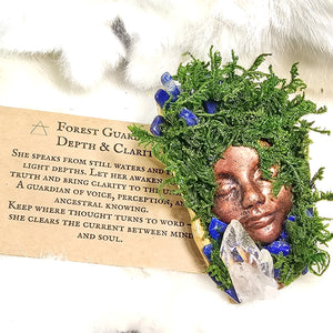 One of a kind moss guardian resting beside invocation card