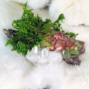 Forest Guardian sculpture with moss, peridot, and clear quartz on driftwood base, side view