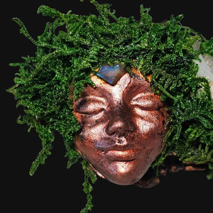 Copper Forest Guardian face surrounded by moss and crystals — witchy home decor symbolising intuition and awareness.