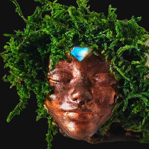 Forest Guardian on dark background — copper face with crystal crown representing insight and balance.