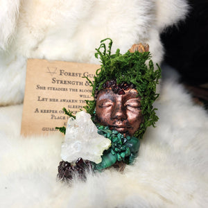 Moss covered guardian sculpture with garnet and malachite crystals