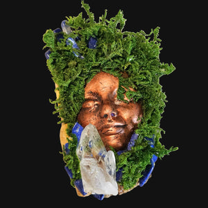Handcrafted Forest Guardian sculpture featuring a copper-bronze face crowned in vibrant preserved moss, with deep blue Lapis Lazuli and a Clear Quartz cluster set upon driftwood.