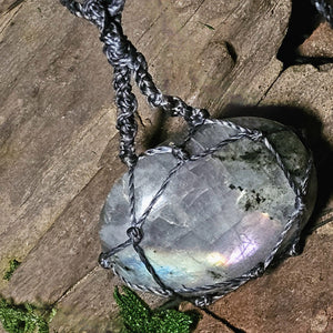 Crystal pendant in natural light highlighting soft pink labradorite flash