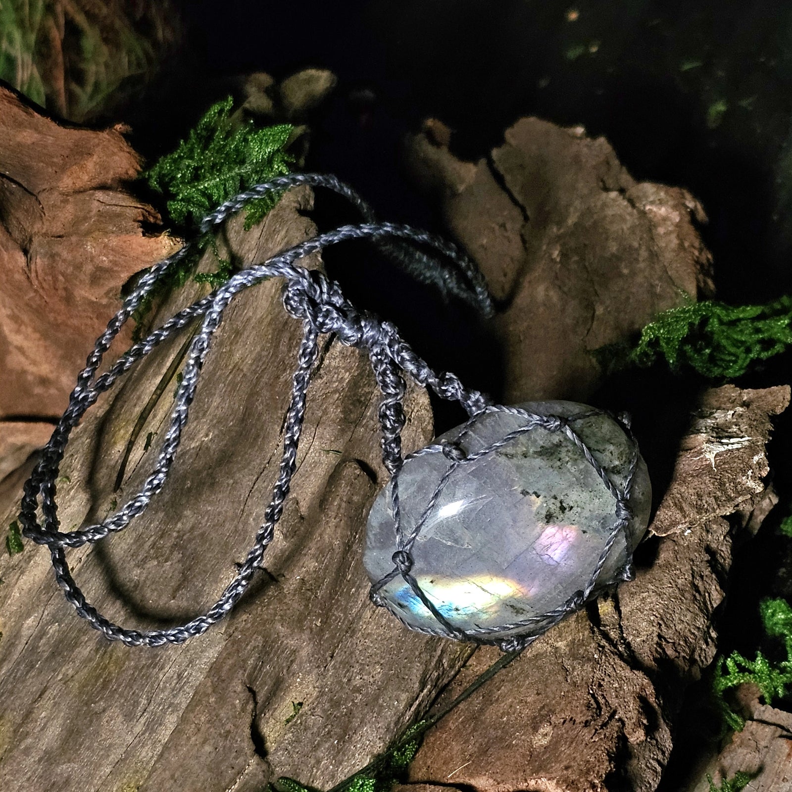 Labradorite pendant with pink flash on grey cord, handcrafted by Moss & Raven