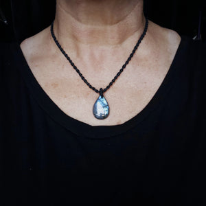 Handcrafted Labradorite teardrop talisman necklace with black cord shown at shortest wearable length