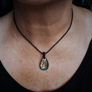 Green gold Labradorite teardrop talisman necklace with black cord shown at shortest wearable length