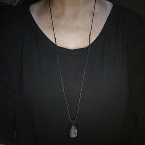 Green gold Labradorite teardrop talisman necklace with black cord shown at longest wearable length