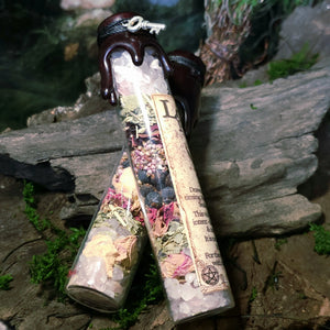 Love Potion Spell Jar displayed on moss and stone.