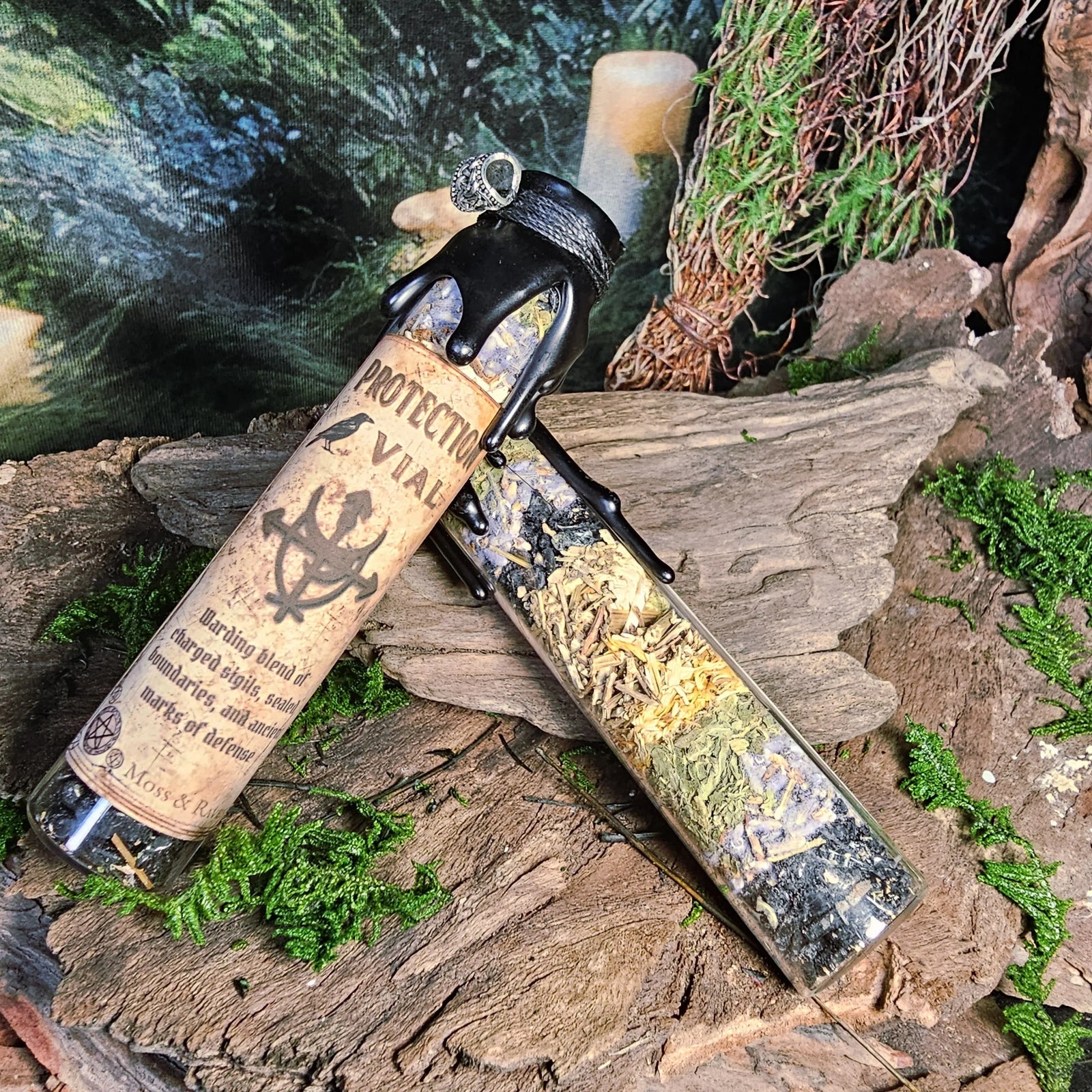 Protection Spell Jar with black tourmaline and herbs on moss