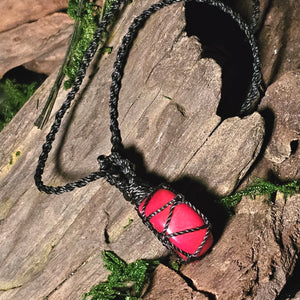 Side view natural coral crystal pendant laid on rustic wood