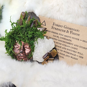 Moss covered guardian sculpture with tiger eye crystal points