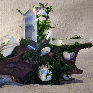 Close-up of Fluorite tower resting beside a Selenite wand and Clear Quartz cluster.