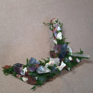Driftwood altar with Fluorite, Amethyst, and Selenite crystals among moss and shells – The Quiet Current by Moss & Raven.
