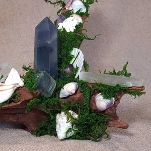 Close-up of Fluorite tower resting beside a Selenite wand and Clear Quartz cluster.