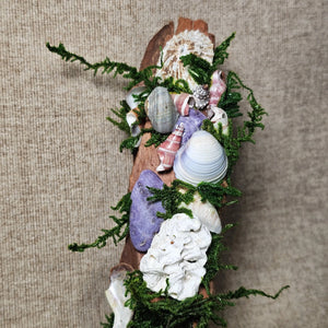 Detail of shell and coral accents set among moss and crystals.