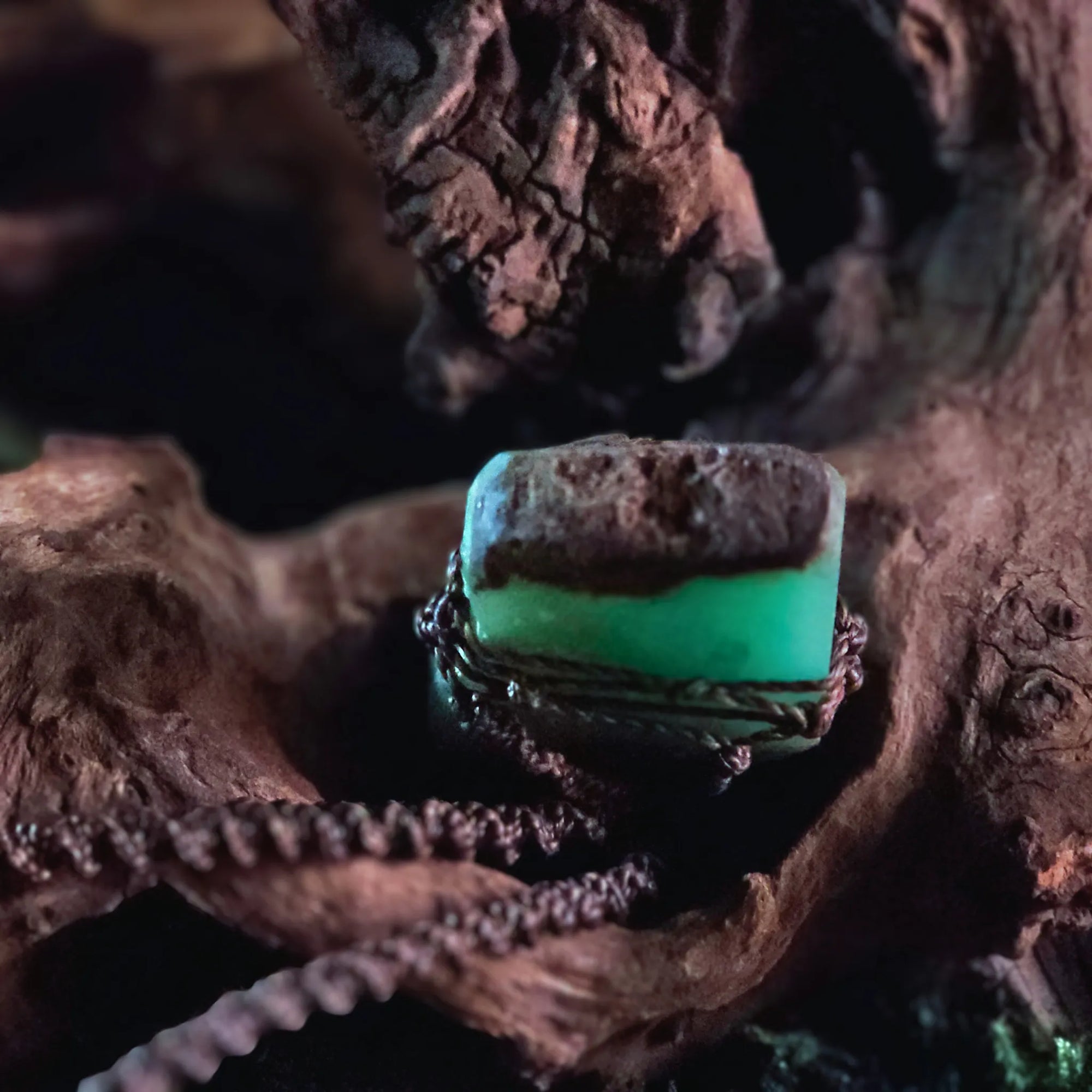 Close-up of raw chrysoprase crystal showing earthy brown matrix and green banding – handwoven talisman by Moss & Raven

