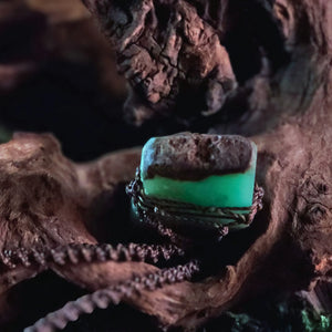 Close-up of raw chrysoprase crystal showing earthy brown matrix and green banding – handwoven talisman by Moss & Raven

