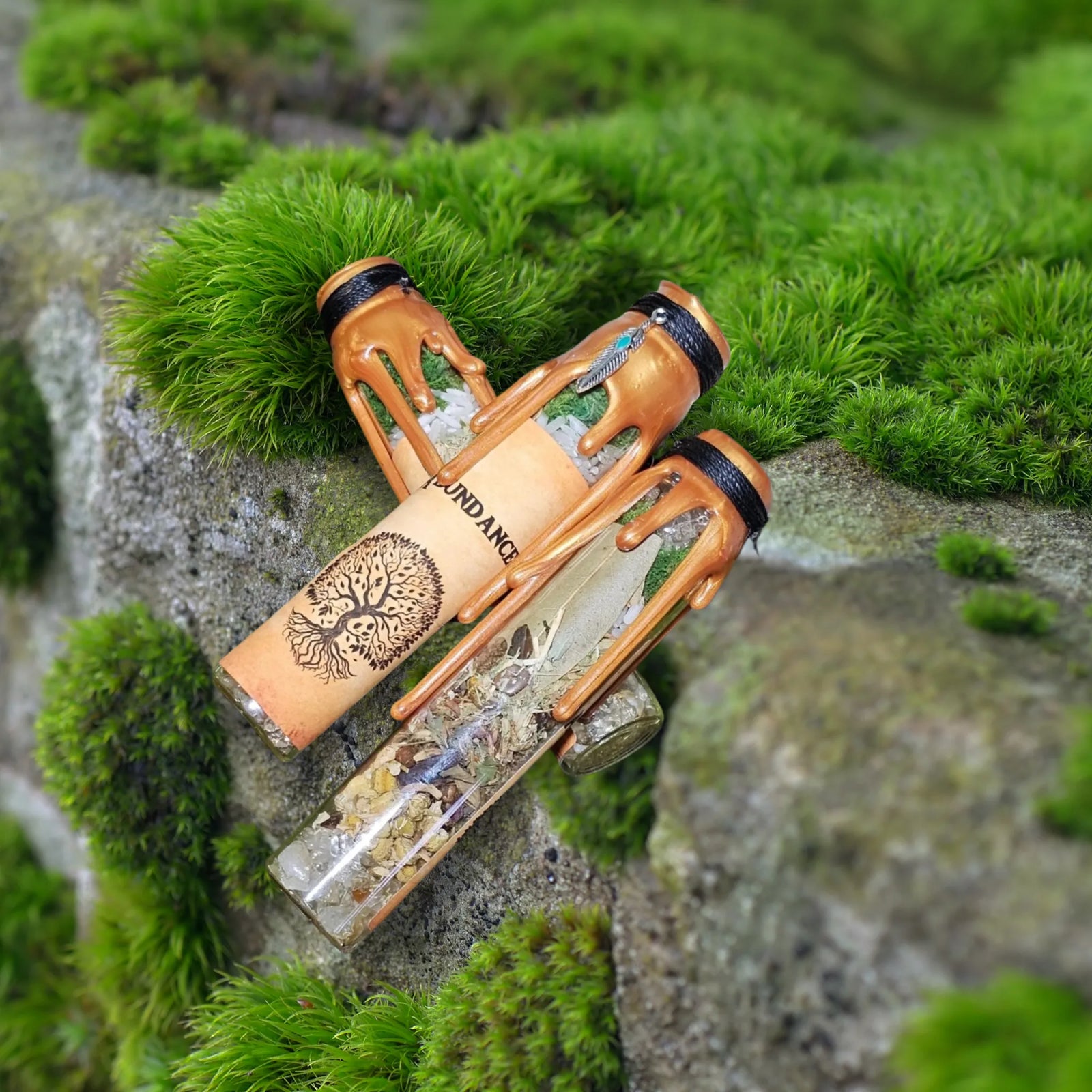 "Empowered Abundance spell jar by Moss & Raven resting on moss and stone, handcrafted with herbs and crystals to support creativity, confidence, and energetic flow."