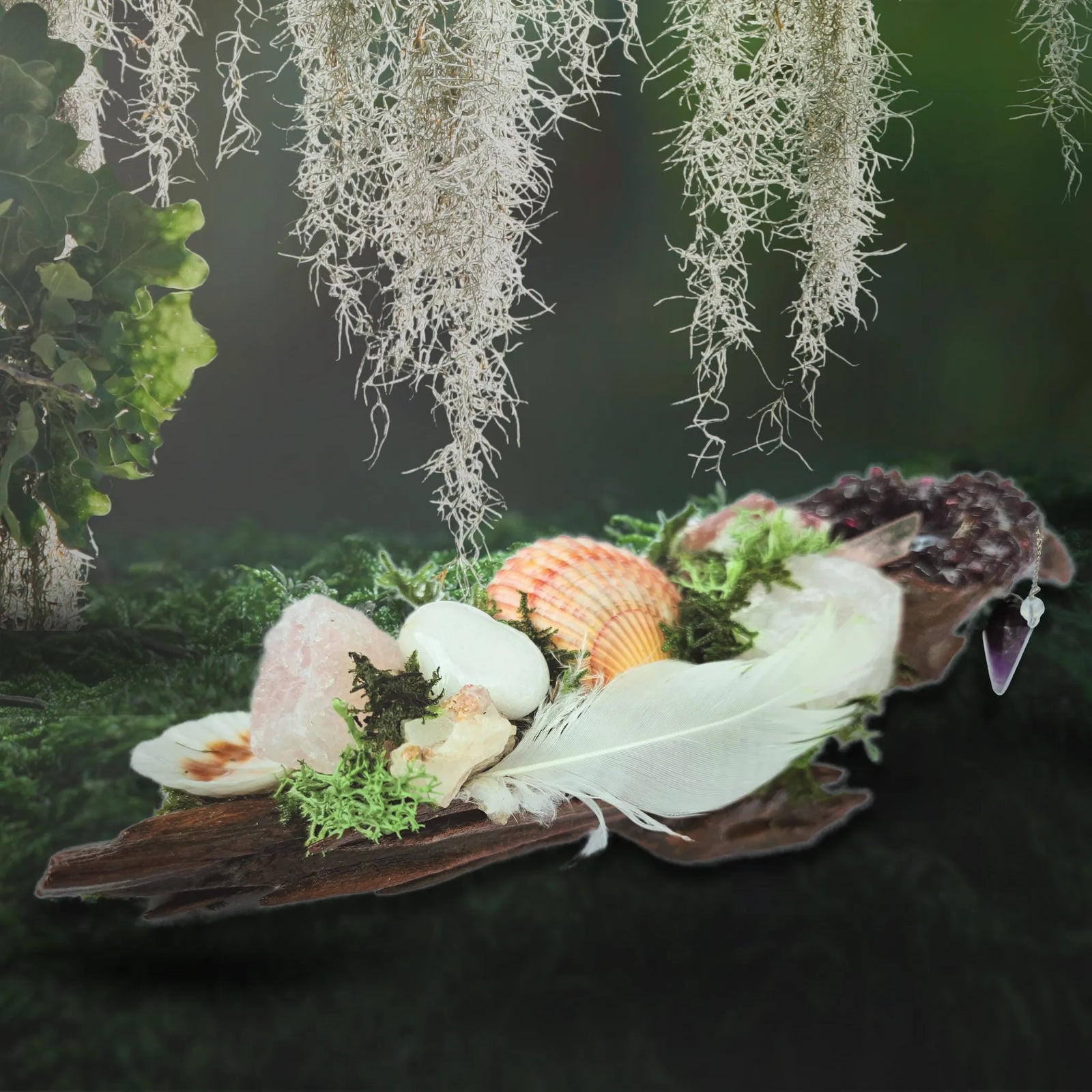 Pendulum of the Soul crystal forest, showing rose quartz, seashells, white feather, moss, and driftwood. against a moss background.