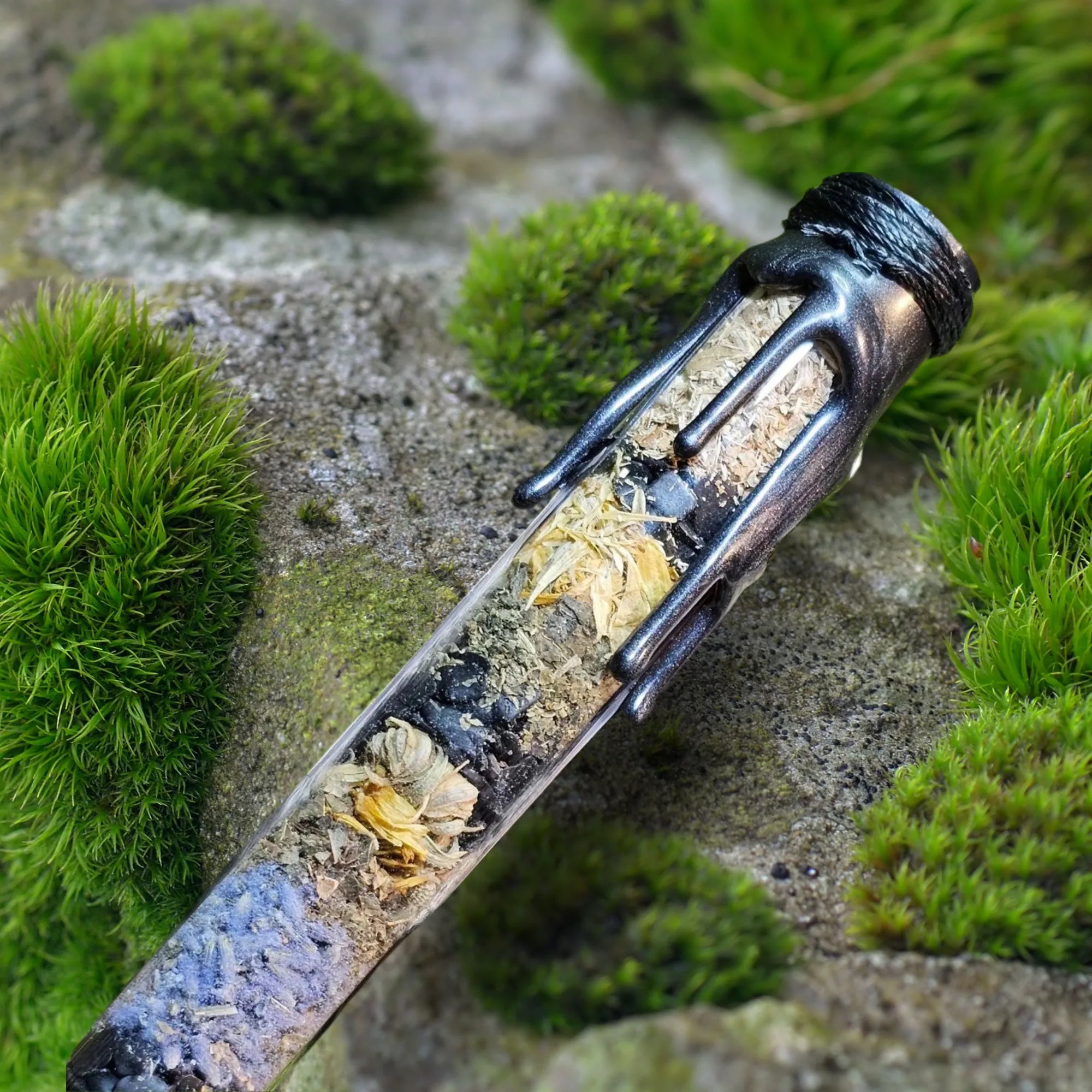 "Protection spell jar by Moss & Raven placed on moss and stone, layered with herbs and crystals for energetic shielding and grounding."