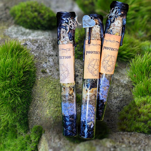 "Protection spell jar by Moss & Raven placed on moss and stone, layered with herbs and crystals for energetic shielding and grounding."