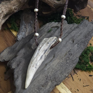 Close-up of the natural antler tip showing texture and soft white howlite beads woven intro the cord.
