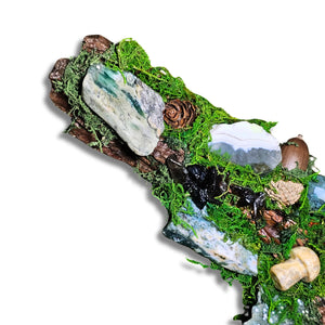 Wyrdwood crystal forest by Moss & Raven on white background. Features Moss Agate, Ocean Jasper, Smokey Quartz, Green Tourmaline, mushroom, moss, driftwood, acorn, and pine cone.