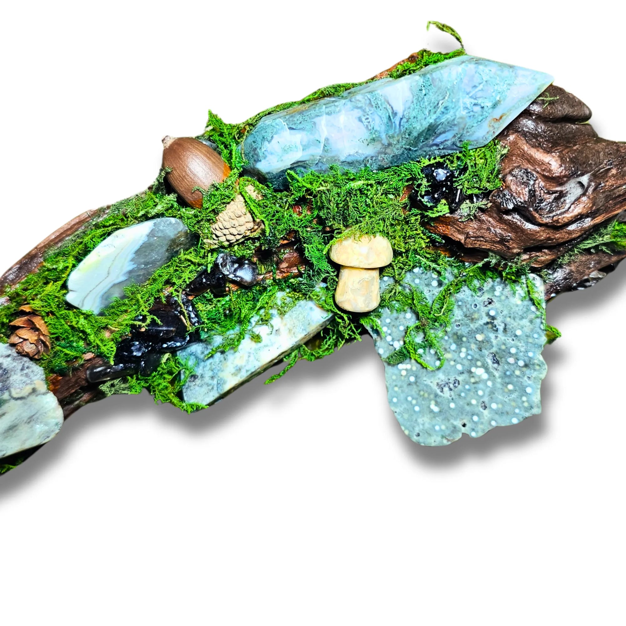 Wyrdwood crystal forest by Moss & Raven on white background. Features Moss Agate, Ocean Jasper, Smokey Quartz, Green Tourmaline, mushroom, moss, driftwood, acorn, and pine cone.