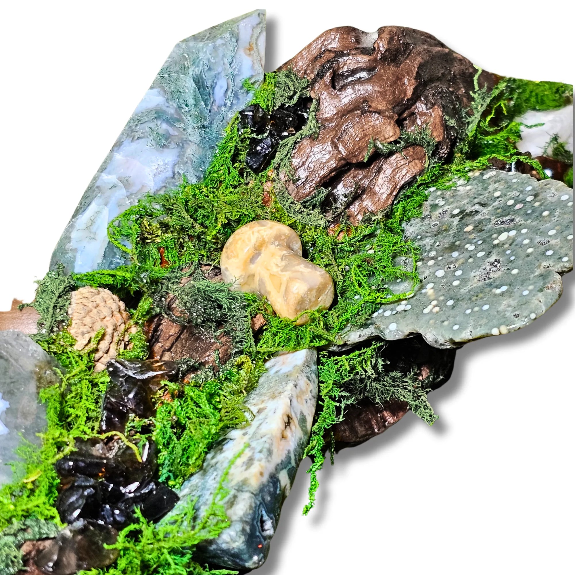 Wyrdwood crystal forest by Moss & Raven on white background. Features Moss Agate, Ocean Jasper, Smokey Quartz, Green Tourmaline, mushroom, moss, driftwood, acorn, and pine cone.