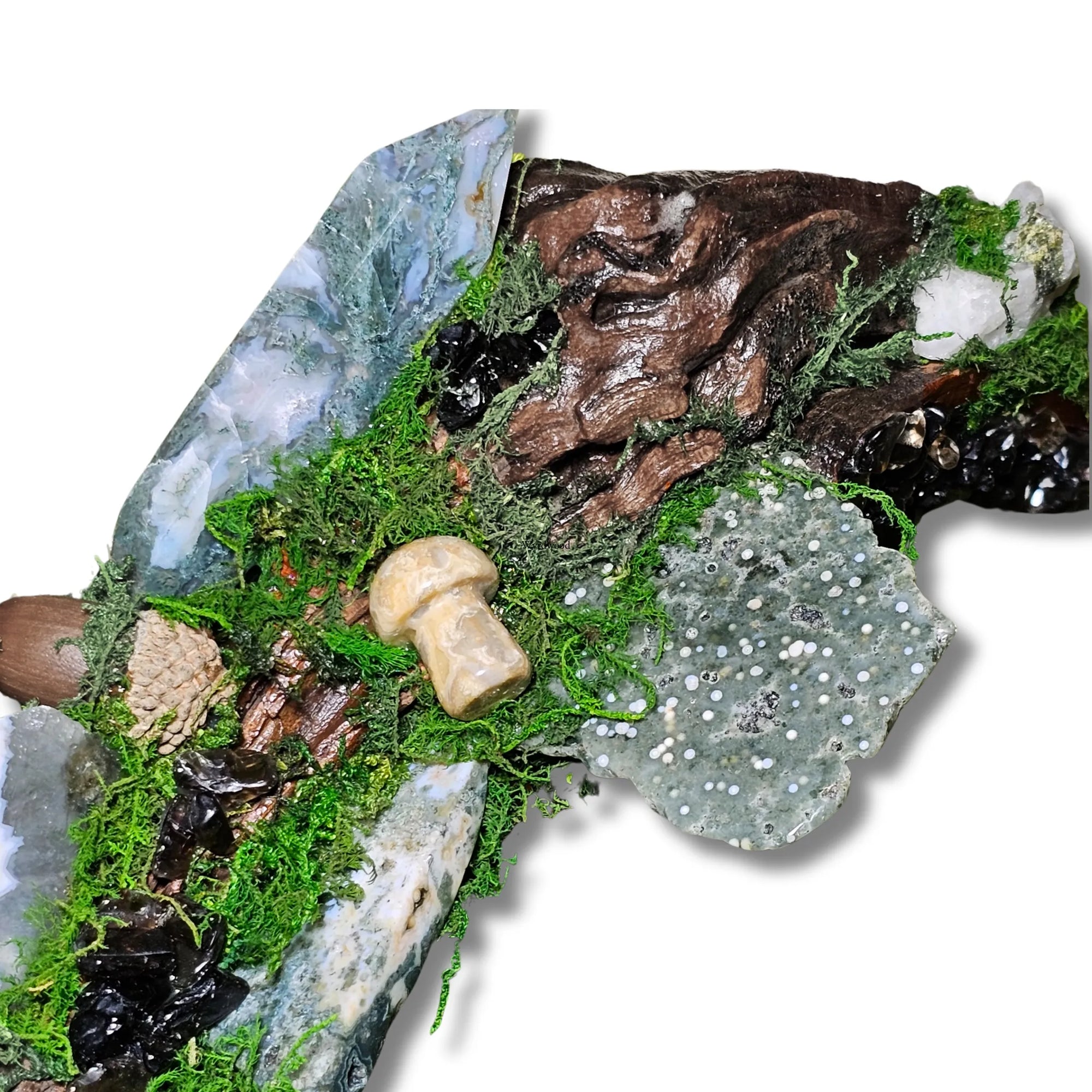 Wyrdwood crystal forest by Moss & Raven on white background. Features Moss Agate, Ocean Jasper, Smokey Quartz, Green Tourmaline, mushroom, moss, driftwood, acorn, and pine cone.




