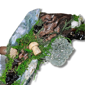 Wyrdwood crystal forest by Moss & Raven on white background. Features Moss Agate, Ocean Jasper, Smokey Quartz, Green Tourmaline, mushroom, moss, driftwood, acorn, and pine cone.




